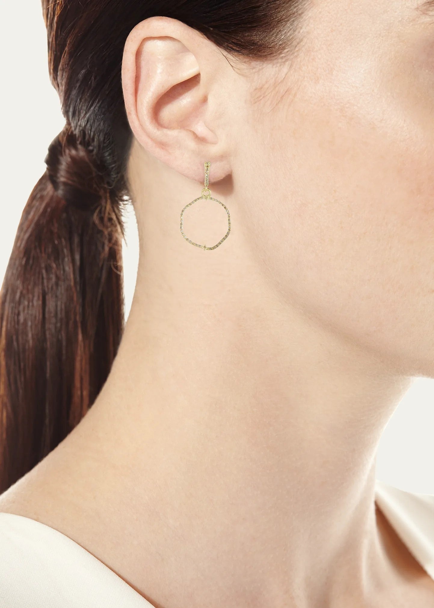 woman wearing diamond hoop earring