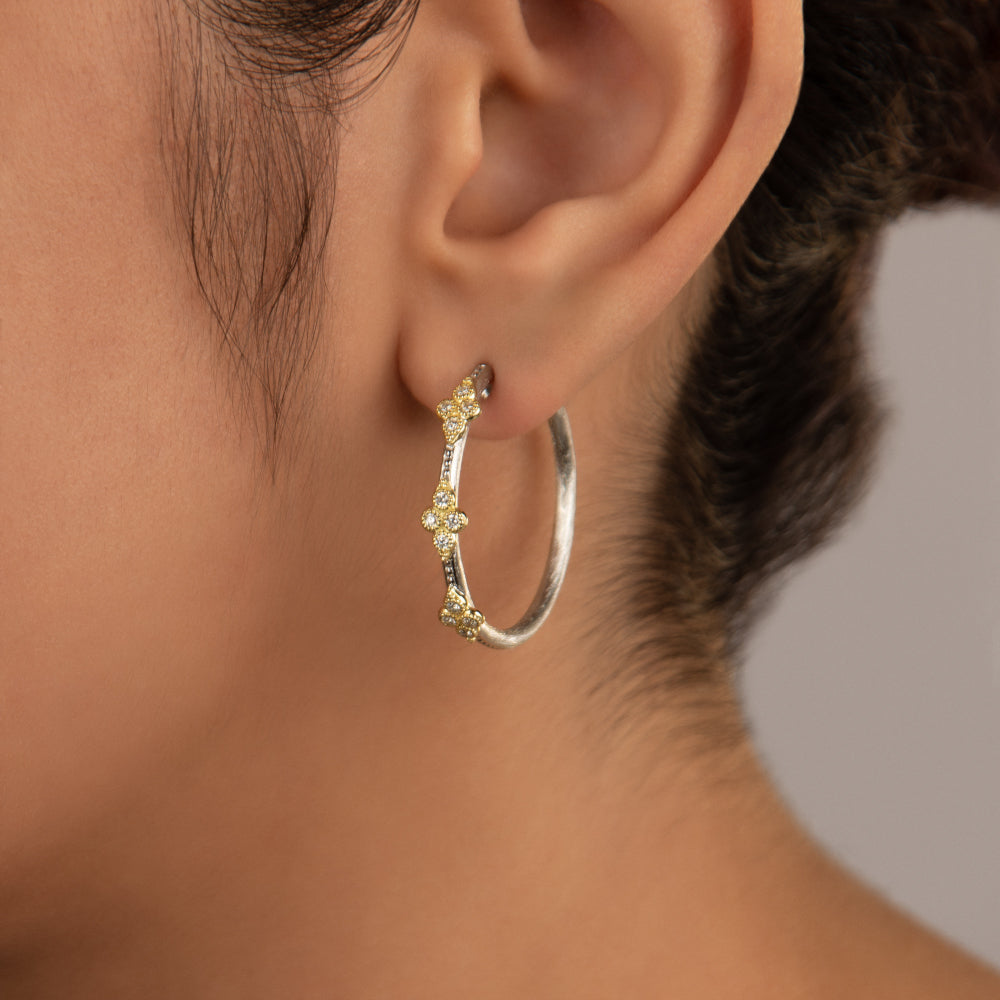 model wearing the silver hoops