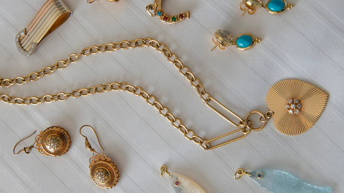 gold necklaces laying down with other jewelry pieces