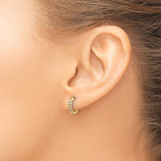 Gold hoop earring worn by a person