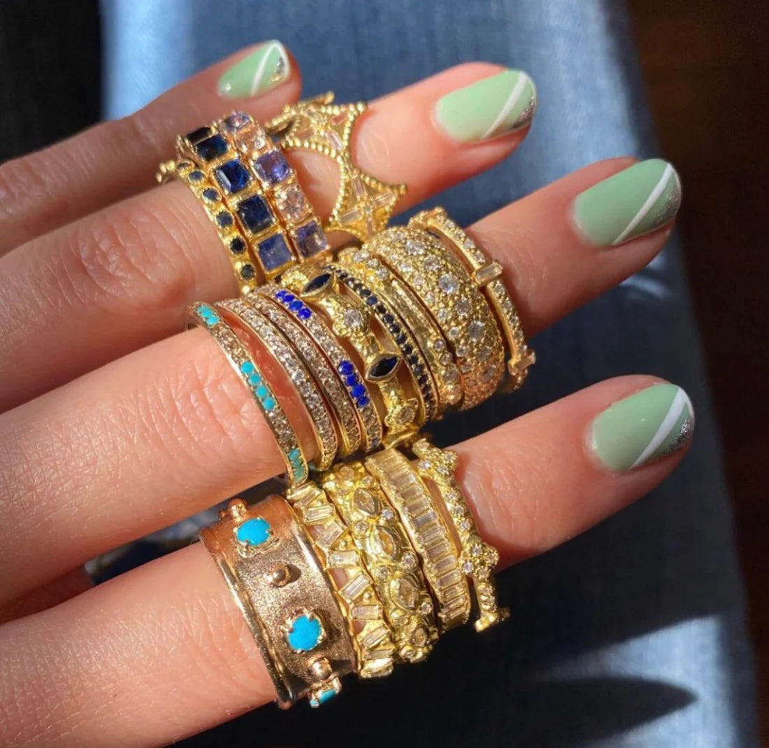 model wearing gold and diamonds rings on hand