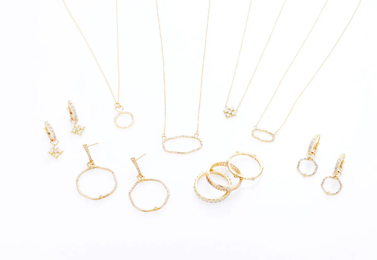 collection of rings, necklaces, and earrings of gold from the same collection