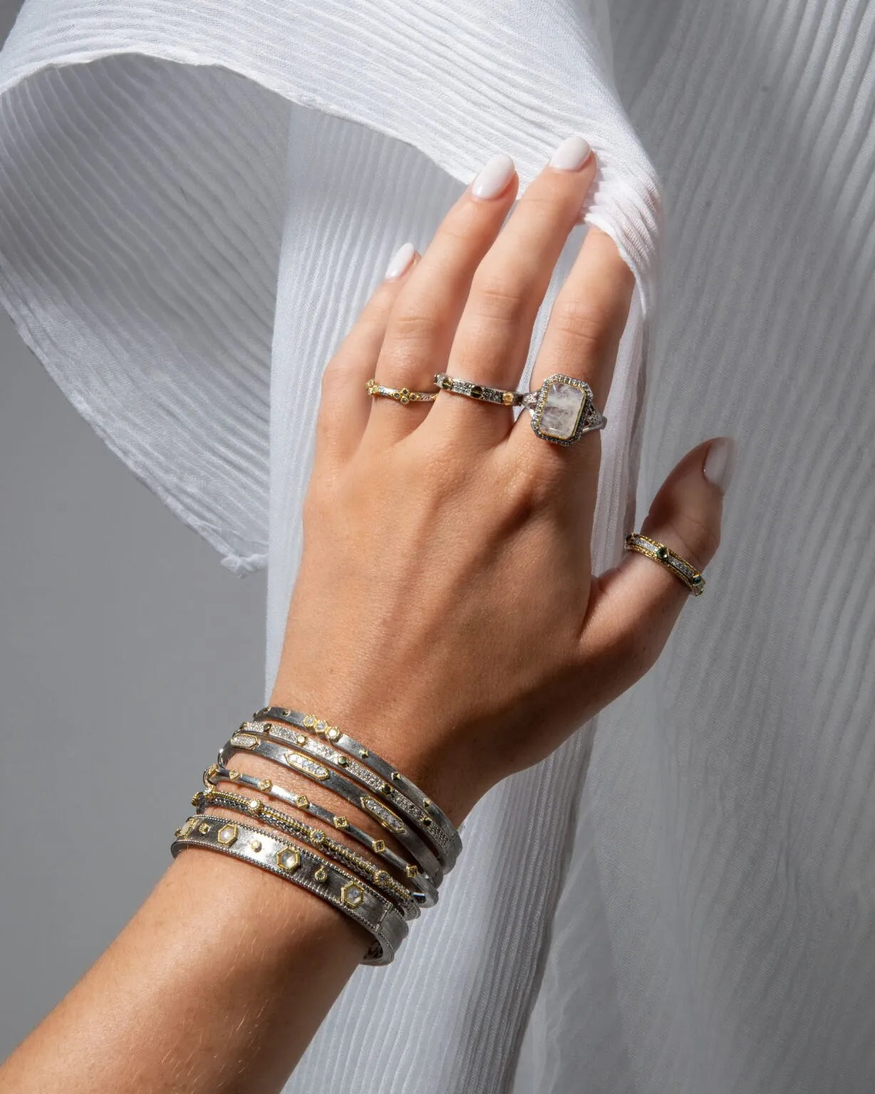 model wearing multiple bangles and rings